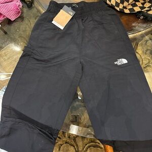 Woman’s black north face windbreaker pants